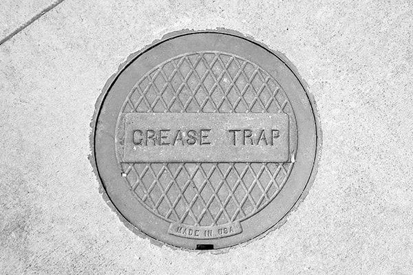grease trap pumping involves removing the built-up grease, food particles, and other waste from the trap